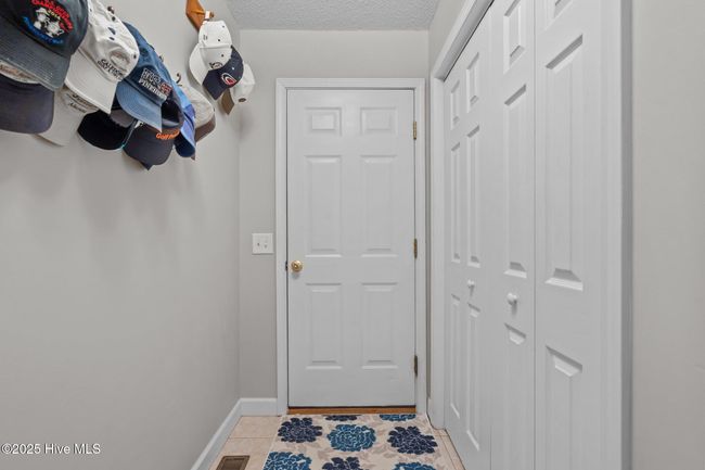 Laundry room leads to garage and storage. | Image 12