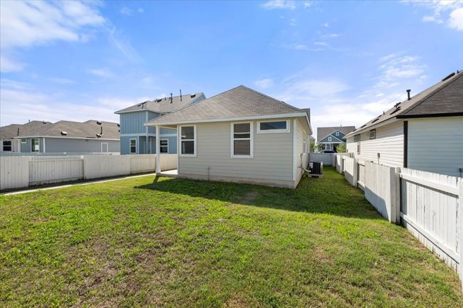 Back of house featuring central air condition unit, a fenced backyard, and a lawn | Image 30
