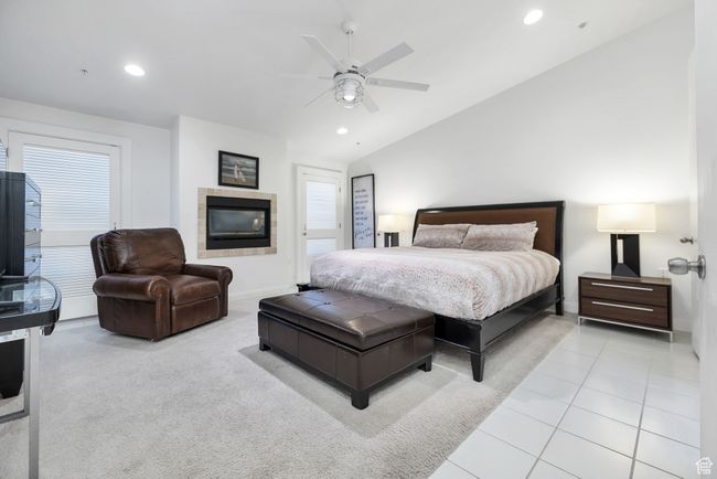 Tiled bedroom with vaulted ceiling, a fireplace, recessed lighting, and ceiling fan | Image 19