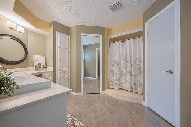 Primary bedroom features plenty of cabinet space, two walk-in closets and a spacious shower. | Image 18