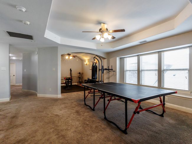 The 2nd floor features an additional living space with a wall of windows and a high tray ceiling. | Image 20