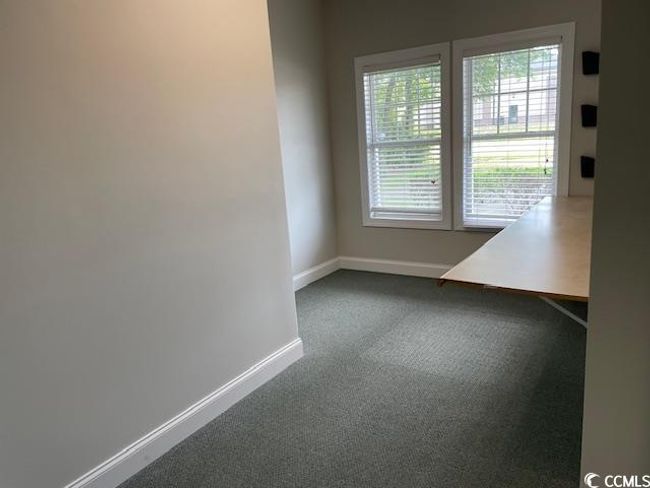 Unfurnished room with baseboards and dark colored carpet | Image 4