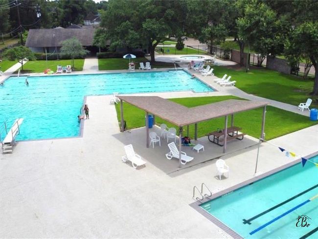 Enjoy a versatile outdoor oasis with a lap pool, recreational pool, and a dedicated area for toddlers. | Image 20
