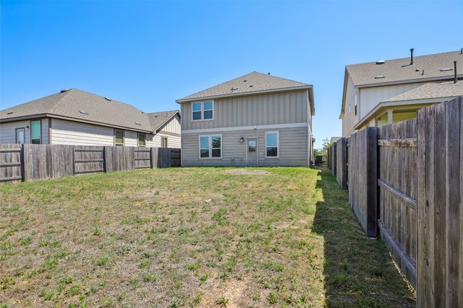 Back of property with a fenced backyard and a lawn | Image 32