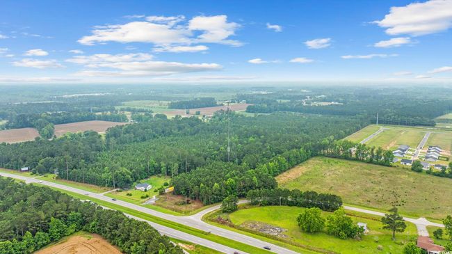 Aerial view of sparsely populated area with a forest | Image 10