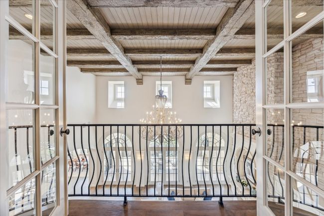 The upstairs interior balcony offers dramatic views of the main level and lake! | Image 11