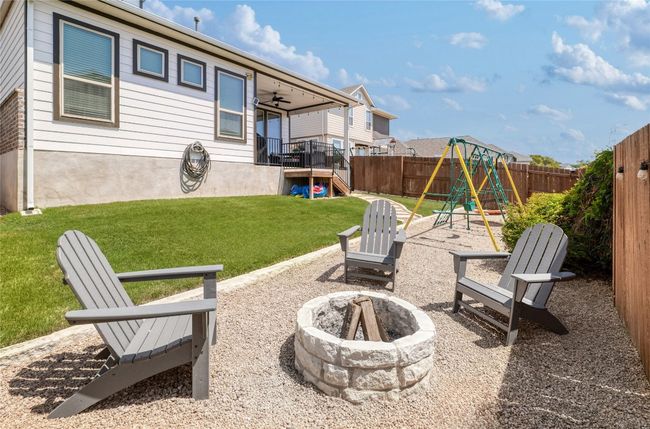 View of patio featuring an outdoor fire pit, and a play area | Image 35