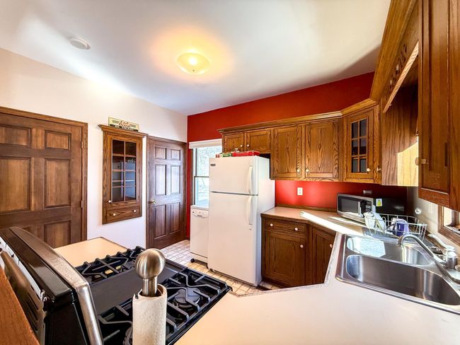 Wrap around counters, along with plenty of natural light sets the warm tone for this kitchen | Image 6