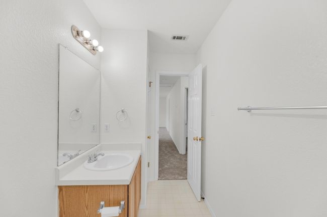 Bathroom featuring visible vents, tile patterned floors, and vanity | Image 28