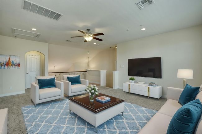 Living room with carpet floors, visible vents, baseboards, and ceiling fan | Image 20