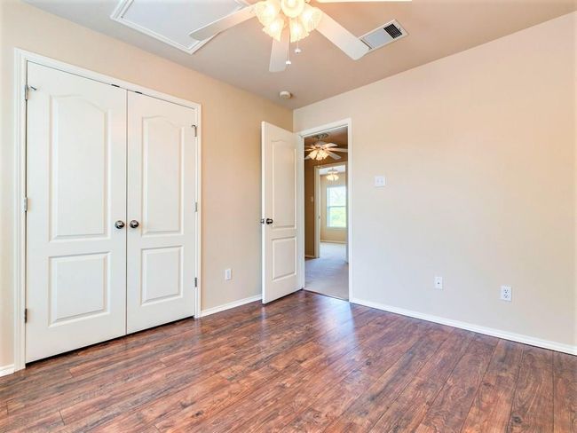 The secondary bedrooms come with ceiling fans and excellent closet storage. | Image 19