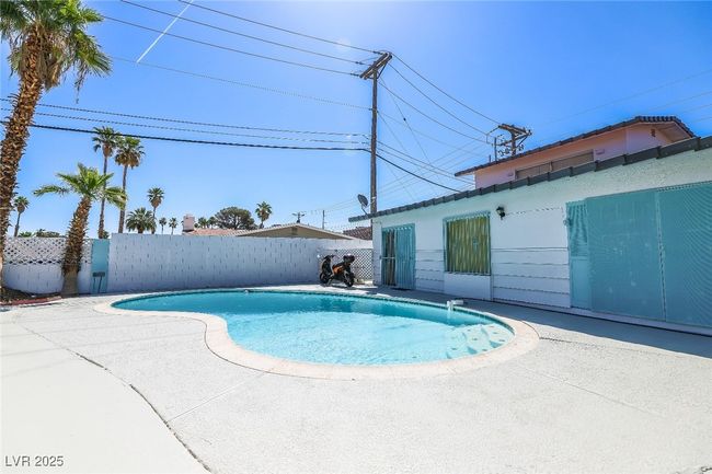 View of pool with a patio and fence | Image 49