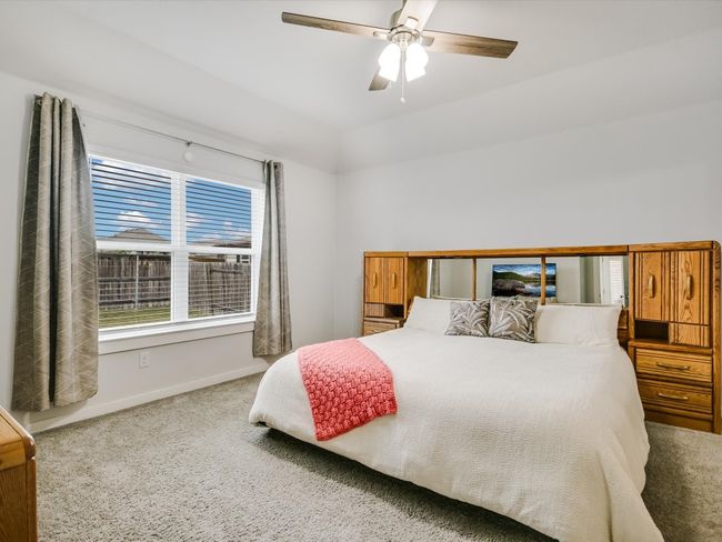 Primary Wing includes a walk through bedroom, bath and closet that connects with the laundry room! Life feels easy breezy on Biscayne Bay Bend with taller, gambrel ceilings, a fan and good lighting! | Image 11