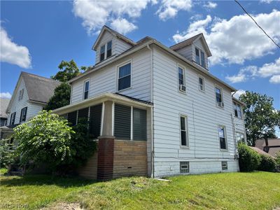 View of property exterior with a yard | Image 2