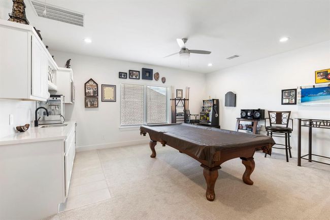 This spacious upstairs game room offers a perfect retreat for entertainment and relaxation, featuring modern amenities and ample natural light. | Image 35