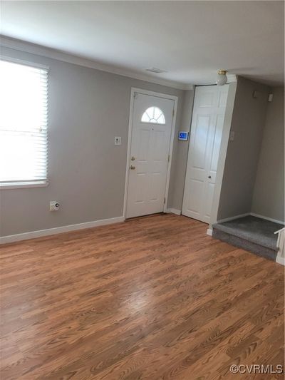 Welcome to 9719...Entrance foyer with hardwood / wood-style floors and ornamental molding | Image 2