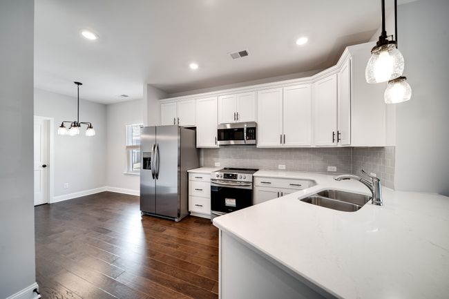 Spacious open kitchen with quarts countertops. | Image 13
