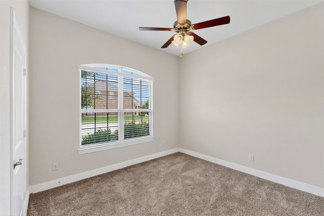 Unfurnished room featuring plenty of natural light, carpet flooring, and a ceiling fan | Image 16