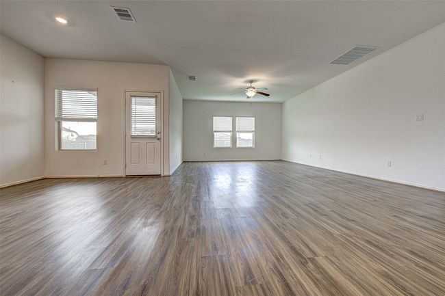 Unfurnished room featuring a ceiling fan, dark wood-style flooring, and baseboards | Image 4