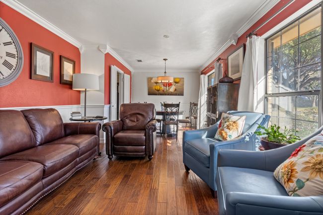 Living room featuring crown molding and dark wood-type flooring | Image 4