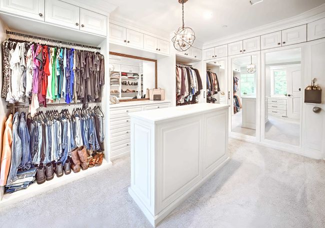 Spacious closet featuring light carpet and a chandelier | Image 29