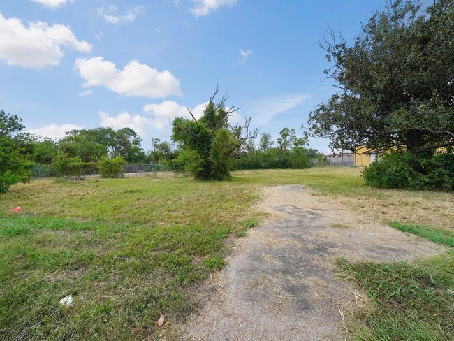 This property in Pasadena features a spacious plot with one of two entrances from Primrose Dr. The land offers a flat and open space, ideal for residential or commercial development. The surrounding greenery provides a pleasant environment, while its strategic location near commercial areas enhances its potential. With easy access and versatile zoning, this property is perfect for a variety of development opportunities in a growing community. | Image 4