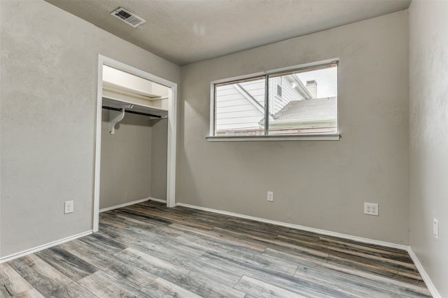Unfurnished bedroom featuring wood finished floors and a closet | Image 18