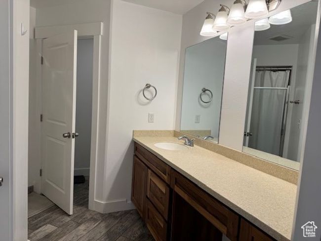 Full bath featuring wood finished floors, visible vents, vanity, baseboards, and a shower with curtain | Image 19