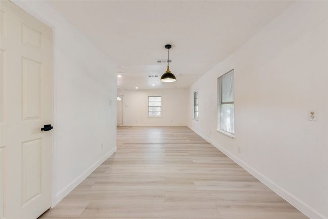 Empty room with visible vents, light wood-style flooring, baseboards, and recessed lighting | Image 10