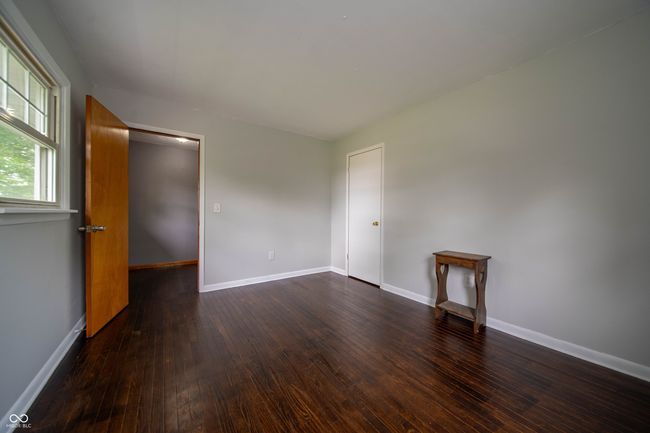 spare room featuring dark wood-style flooring and baseboards | Image 38