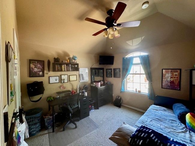 Carpeted bedroom featuring ceiling fan and vaulted ceiling | Image 18