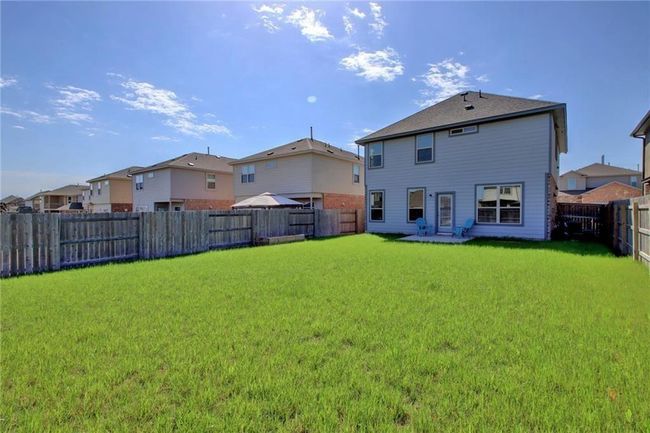 Back of property featuring a fenced backyard and a residential view | Image 34