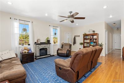 Living room with ceiling fan, wood flooring, 9 ceilings and a wealth of natural light | Image 3