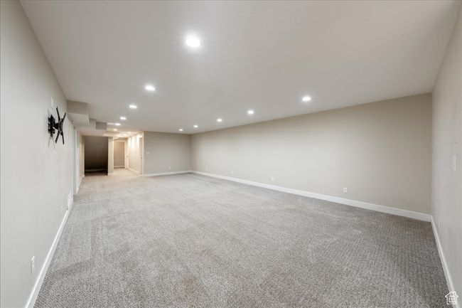 Finished below grade area featuring recessed lighting, baseboards, and light carpet | Image 42