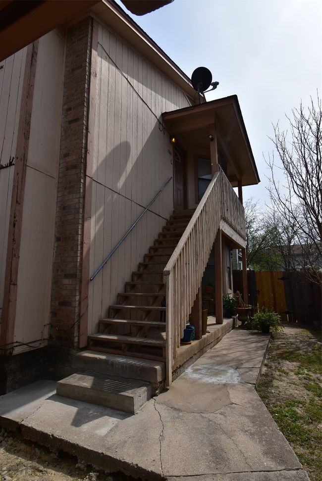 View of property exterior with stairway and brick siding | Image 15