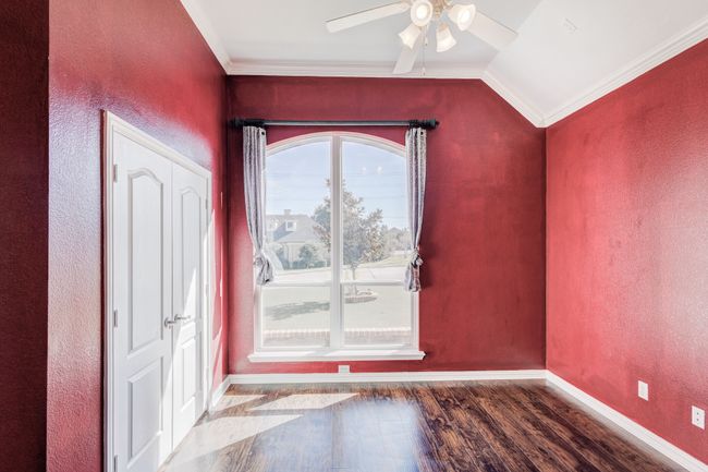 Foyer with ceiling fan, dark wood-type flooring, crown molding, and vaulted ceiling | Image 8