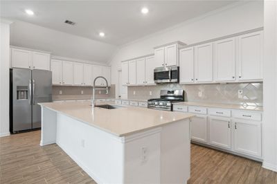 A view of the kitchen with its HUGE island and lots of cabinets and countertop space! | Image 2