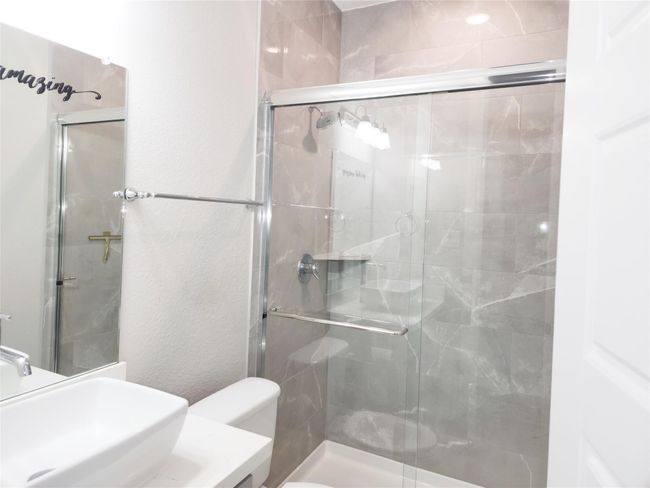 Secondary bathroom, on first floor showcase over top sink and beautiful finishes. | Image 19