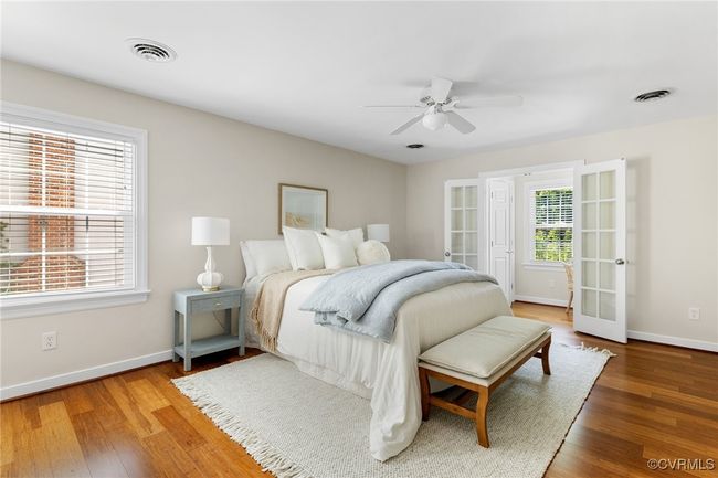 Large Primary Bedroom featuring wood finished floors, large walk-in closet and French doors to work/hobby area. | Image 27