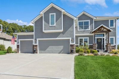 Craftsman house featuring a front yard and a garage | Image 3