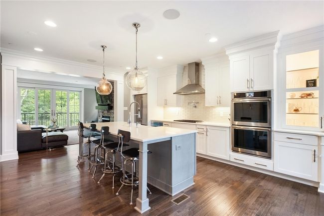Hardwood floors continue from Family Room into the gourmet Kitchen. | Image 8
