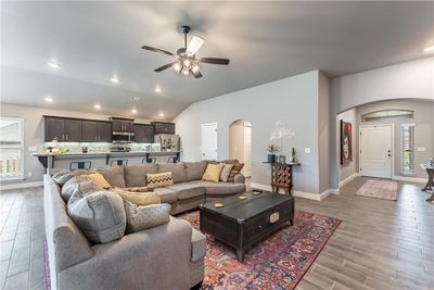 Living room is at the heart of this split floorplan home. Tile flooring throughout the main living area. | Image 2