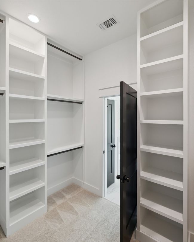 Spacious closet with light carpet | Image 33