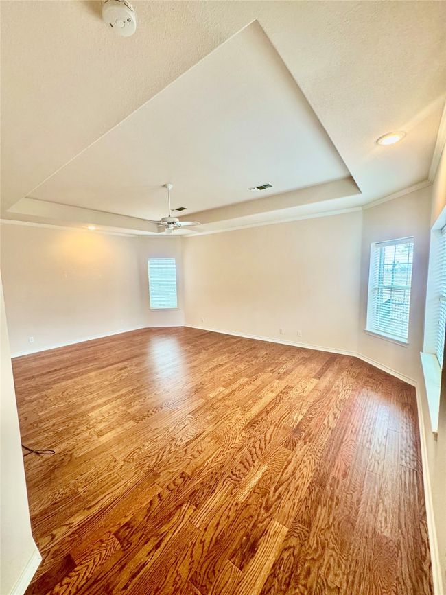 Oversize primary suite with true hardwood floors and a tray ceiling | Image 7