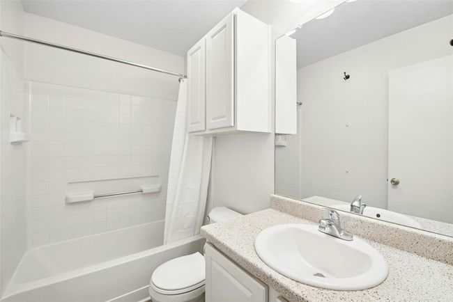 Bathroom featuring vanity and shower / bath combo with shower curtain | Image 22