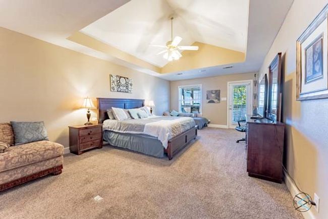 Large primary suite offers plenty of extra room with a seating area, an ensuite bath and private access to the screened balcony. | Image 14