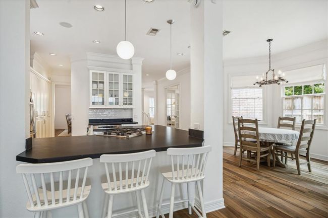 Open concept kitchen with counter height seating. | Image 8