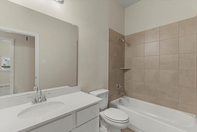 Second bathroom with vanity, tub / shower combination, and toilet. | Image 18