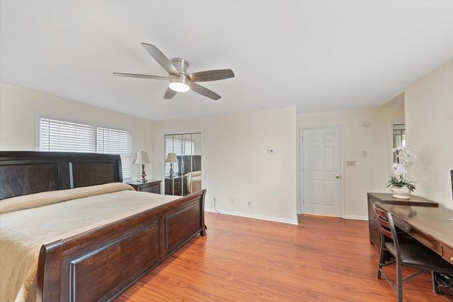 Bedroom featuring light wood-style flooring, baseboards, and ceiling fan | Image 16