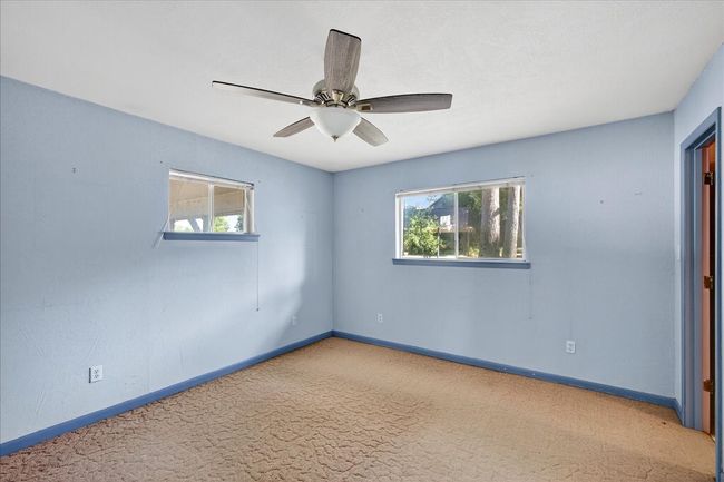 Carpeted empty room featuring plenty of natural light and ceiling fan | Image 29